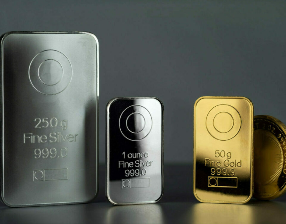 Gold vs. Silver, 1oz fine silver bullion, and 50g fine gold bullion bar.