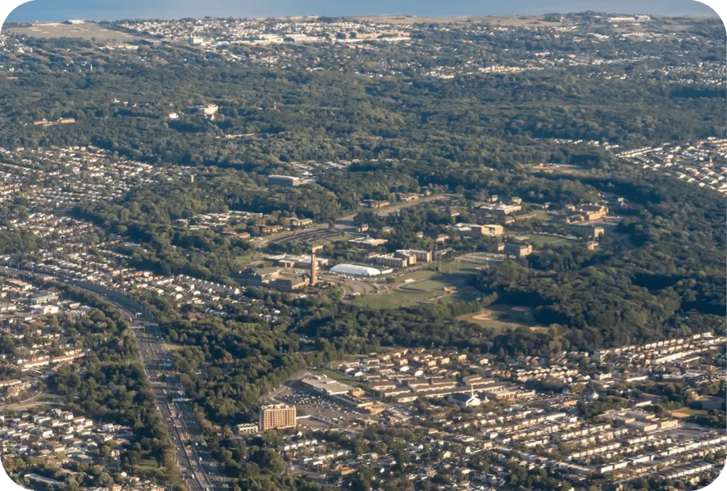 Aerial view of Staten Island with residential neighborhoods, highways, and a large green campus area