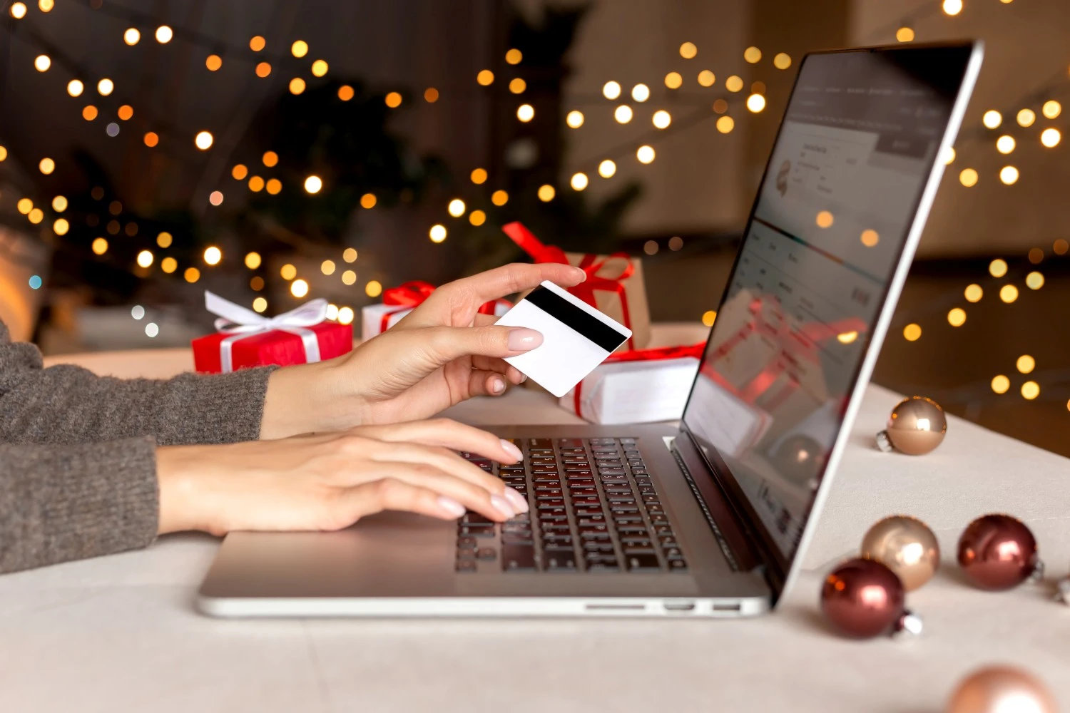 Hands holding a credit card while shopping online during the holidays, illustrating how same-day jewelry loans from Qollateral help fund Black Friday and Cyber Monday purchases without using high-interest credit cards.