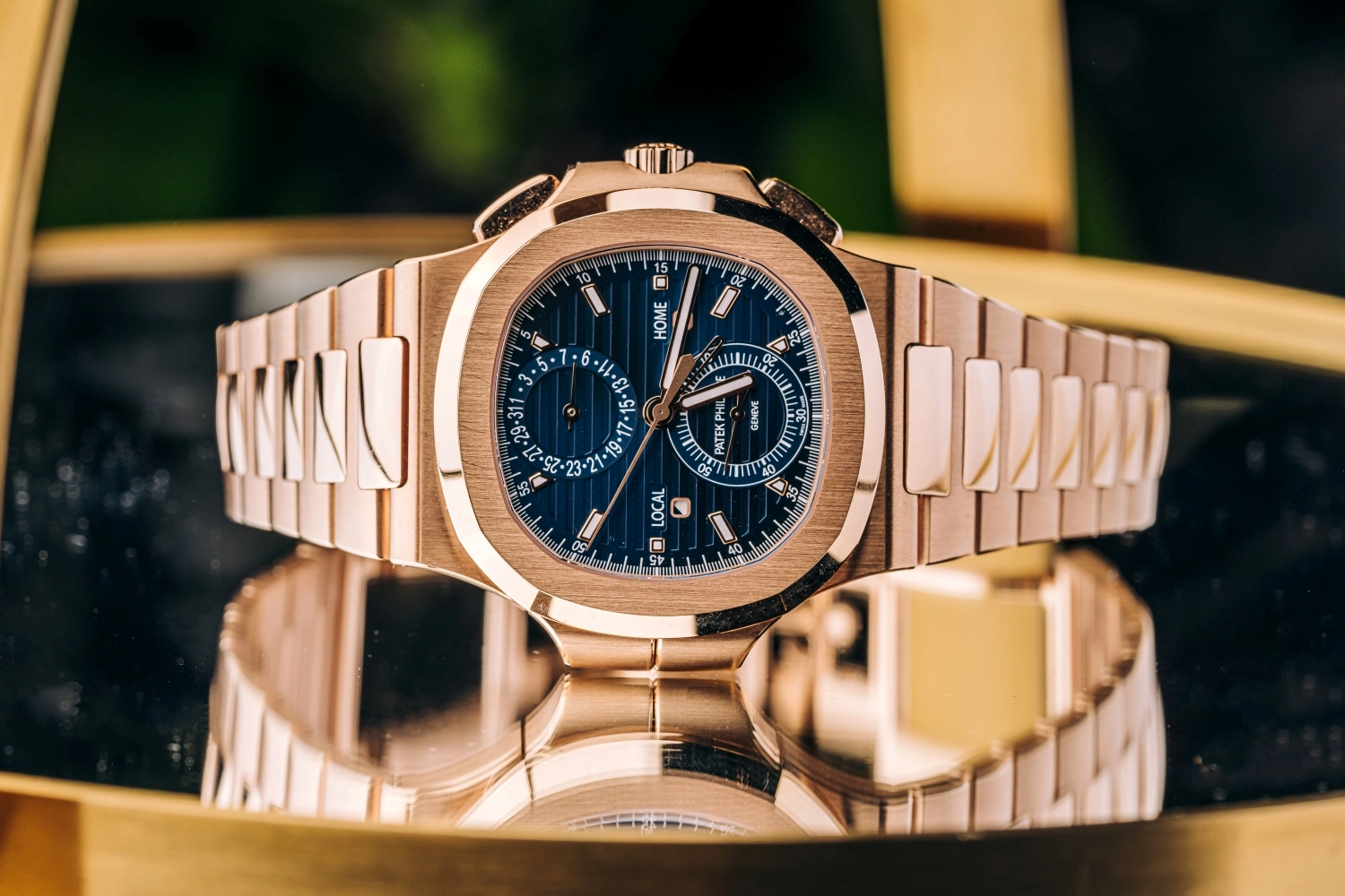 Rose gold Patek Philippe Nautilus luxury watch with blue dial and integrated bracelet