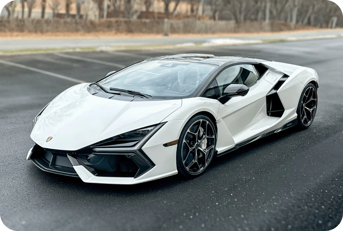 White Lamborghini Revuelto V12 hybrid supercar parked on a paved surface