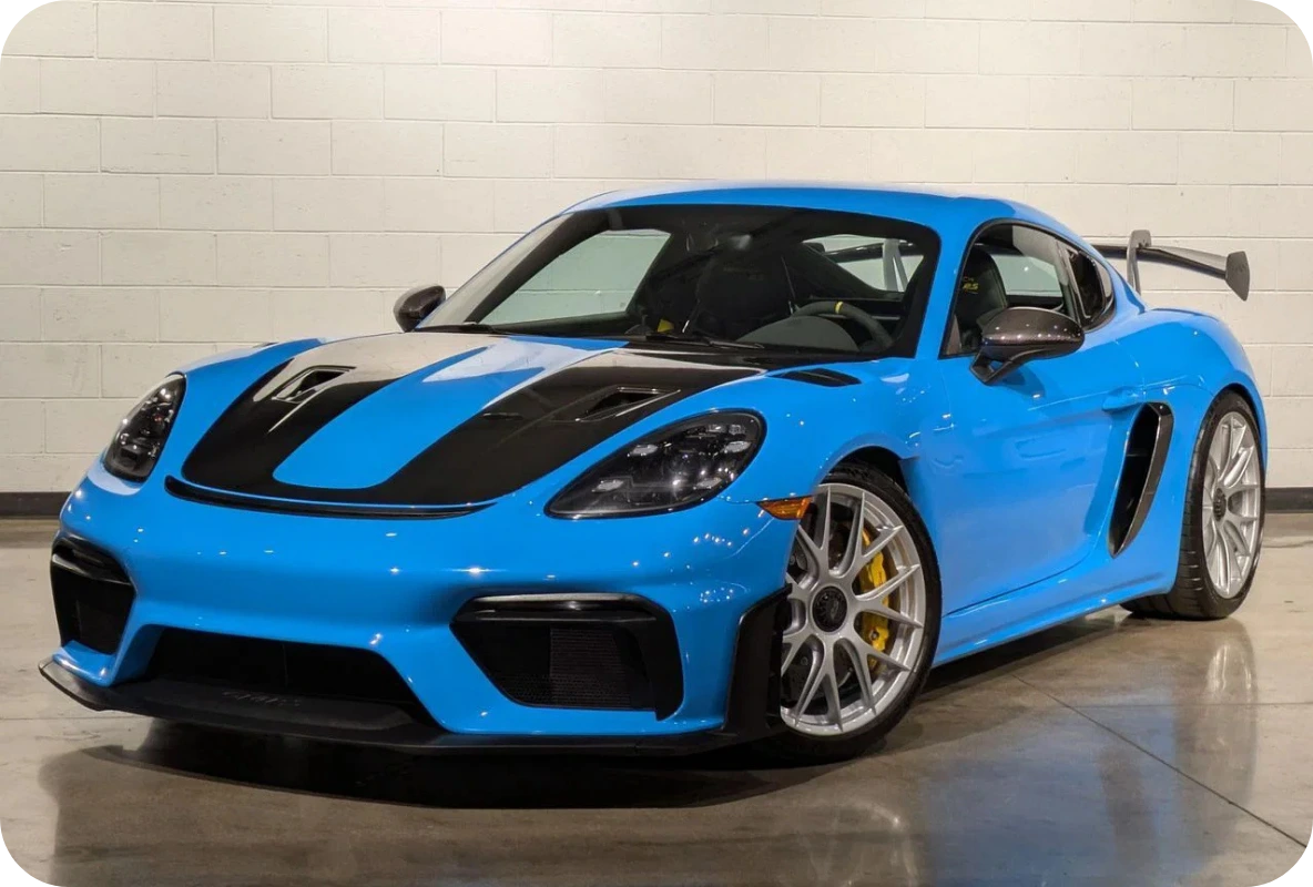 Blue Porsche 718 Cayman GT4 RS with exposed carbon fibre hood and rear wing