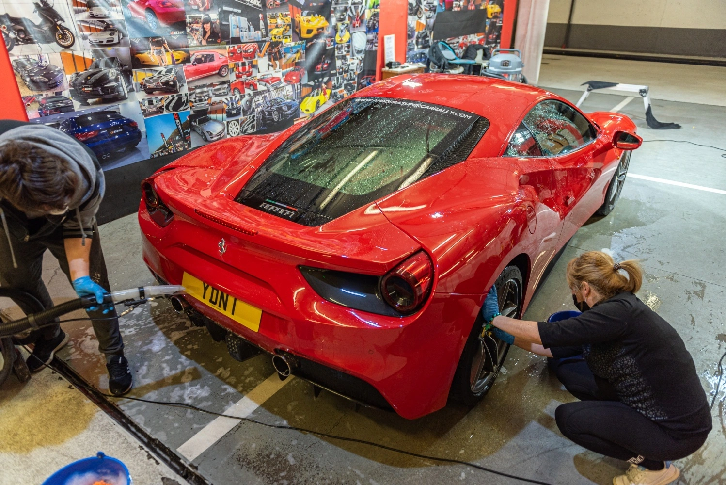 Red Ferrari 488 receiving professional detailing before an exotic car appraisal for a luxury collateral loan.