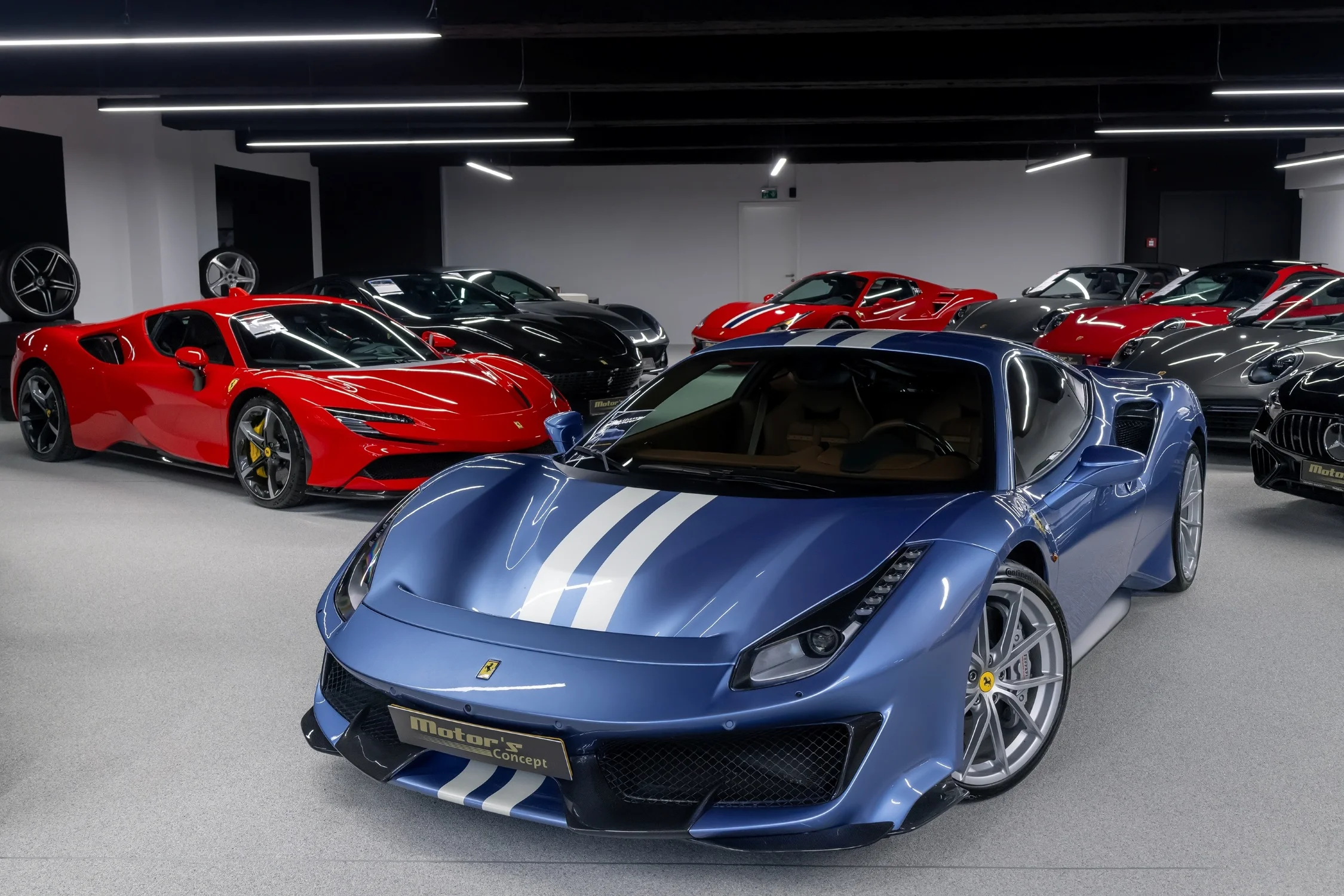 Ferrari 488 Pista in an exotic car showroom with other high-value collector cars